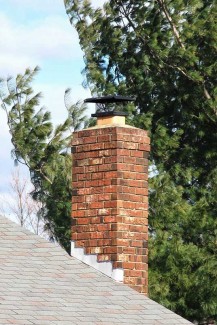 metal chimney cap on masonry chimney