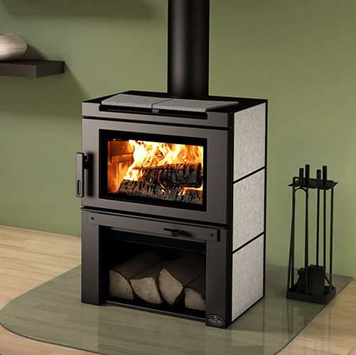 Osburn Matrix Wood Stove with Blower, wood below and tools to the right.