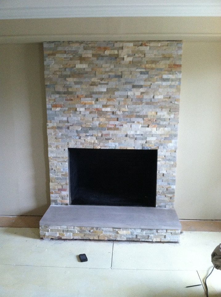 Newly built fireplace and hearth with light brown and greay bricks