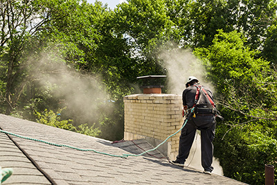 Tech working on chimney - Ashbusters Chimney