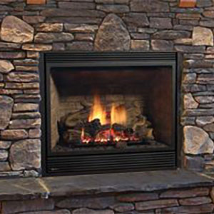 black fireplace with fire burning it and different shape bricks on the hearth wall behind it