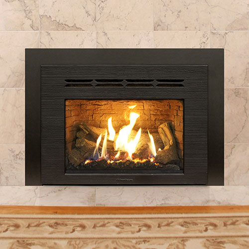 fire burning inside black gas fireplace insert with large white brick hearth