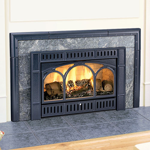 wood burning in black gas fireplace insert grey brick is framed in black wood