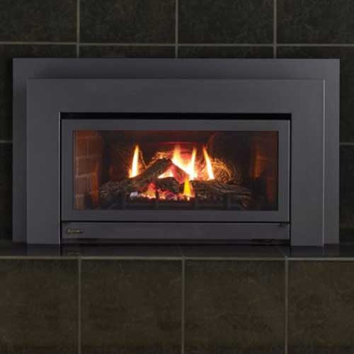 fire burning in gas fireplace insert it is metal and black with large square tiles on the background