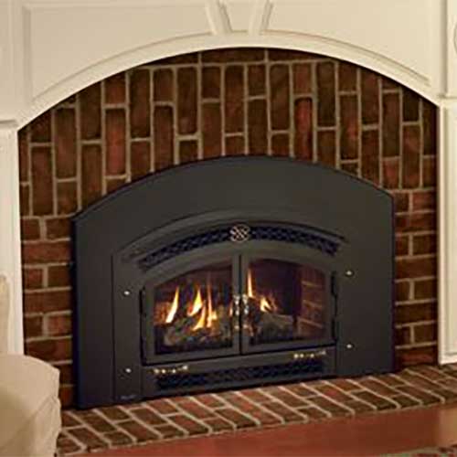 arch shaped black metal fireplace insert with doors and dark brown brick arched hearth fire is burning in it