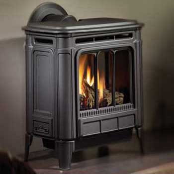 Large black gas stove with circle vent on back wall of home