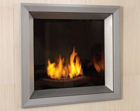 Sqaure metal fireplace insert with silver framing and brick background