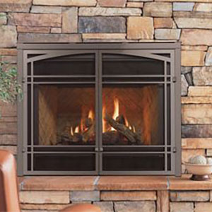 arched fireplace insert with doors and bricks with mixed pattern