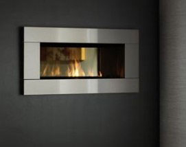 rectangular fireplace insert with silver framing and glass face on a black wall