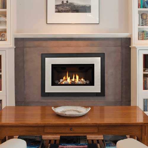 brown coffee table with white plate on it with white fireplace insert with fire burning