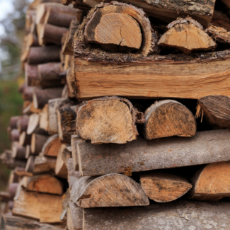 a pile of seasoned firewood stacked outside