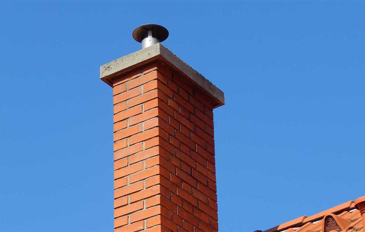 Tall chimney with older cap - we fix leaky chimneys.