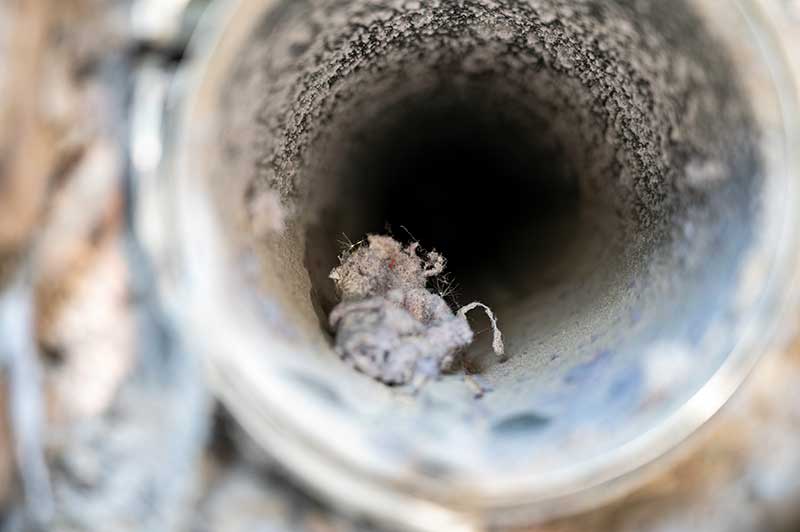 Interior View of a Dryer Vent with lint Interior View of a Dryer Vent with lint